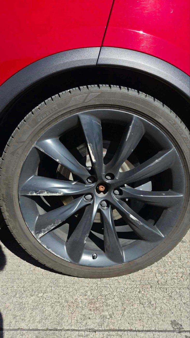 Dark wheel on a red vehicle
