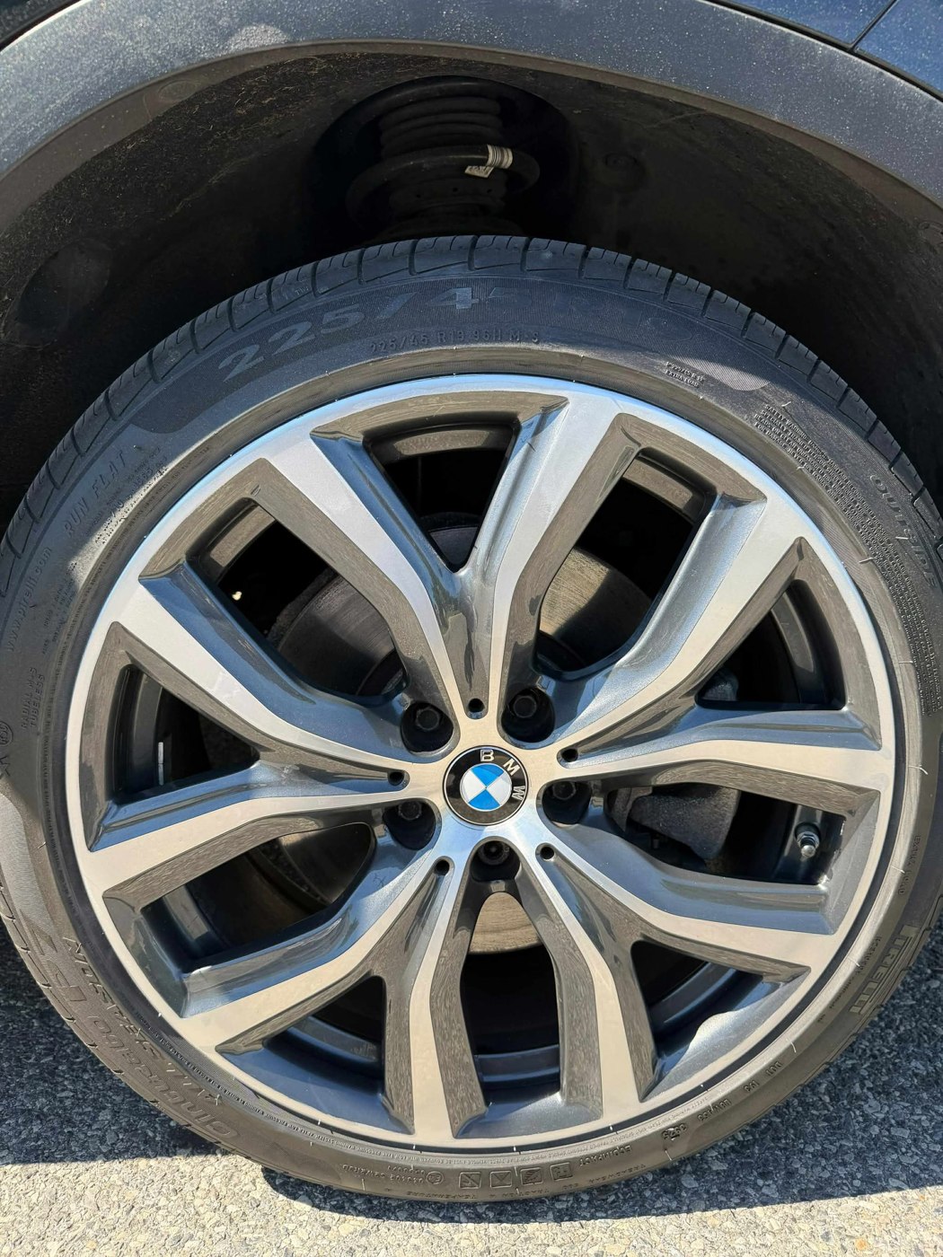 BMW wheel with a clean refinished metallic surface